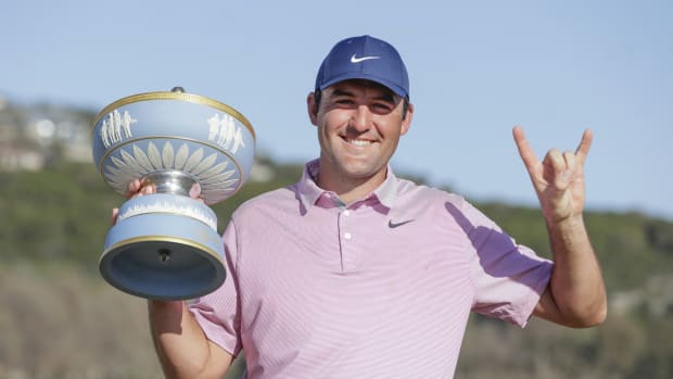 Mar 27, 2022; Austin, Texas, USA; Scottie Scheffler gestures while holding the Walter Hagen Cup after defeating Kevin Kisner (not pictured) in the final round of the World Golf Championships-Dell Technologies Match Play golf tournament. Mandatory Credit: Erich Schlegel-USA TODAY Sports